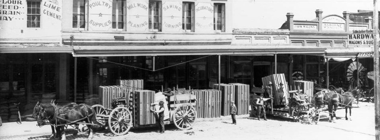 Petaluma's rich history 6 Historic black and white of horse-drawn carts and man loading one