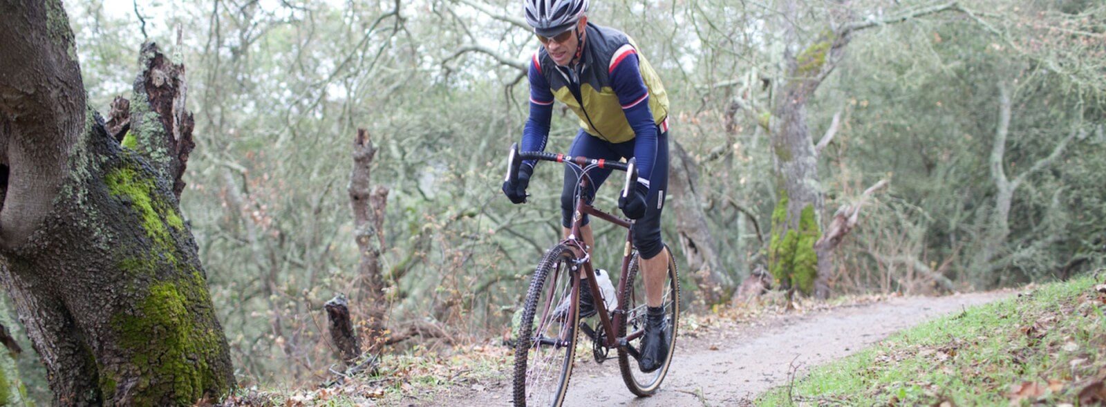 Man on mountain bike on wooded trail