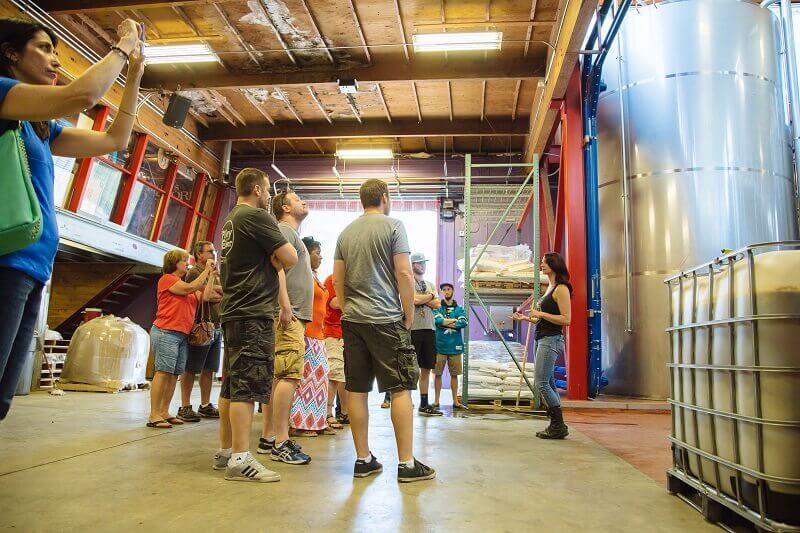 Group tour inside a brewery facility.