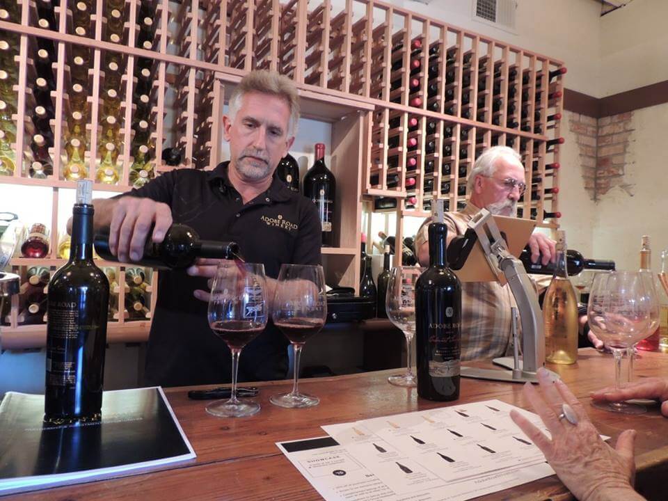 Man pouring wine at a tasting room.