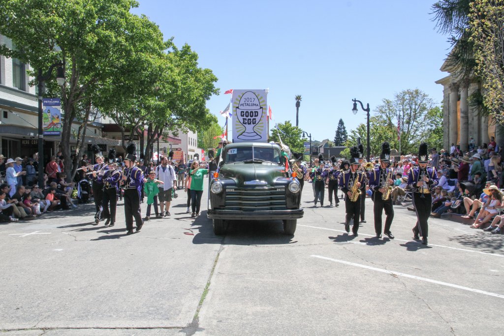 Vintage truck with banner "2017 good egg," flanked by marching band