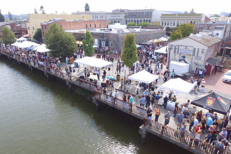 Crowd at outdoor festival by water