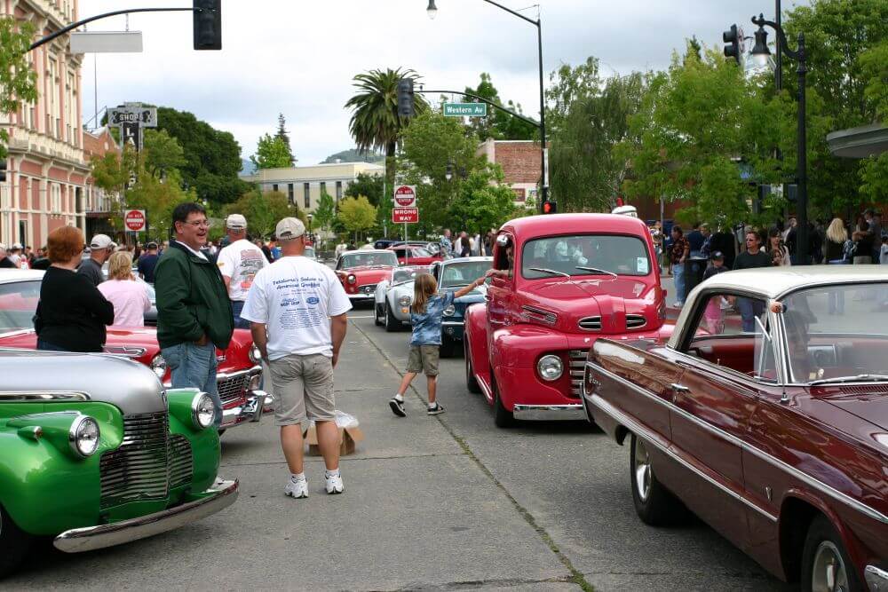 Classic cars and people watching them cruise