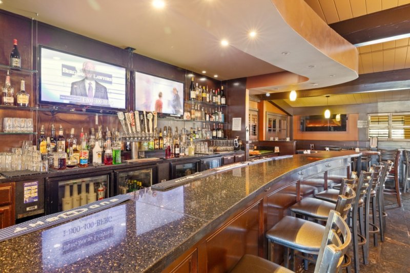 Modern bar with drinks and screens