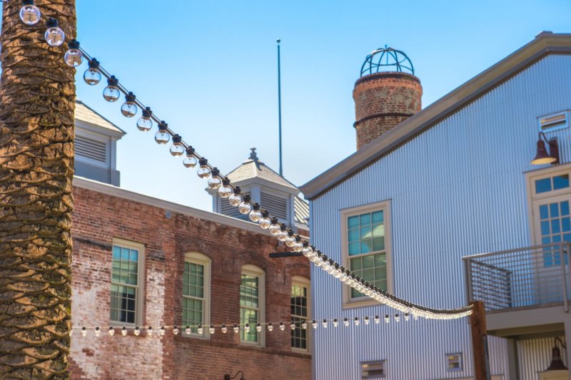 Historic brick building with market lights strung