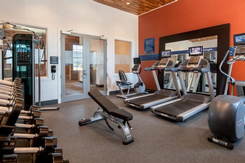 Hotel gym with treadmills, free weights and weight bench