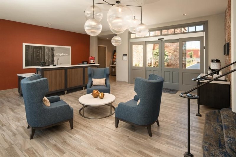 Hotel lobby with modern chandelier and wingback chairs