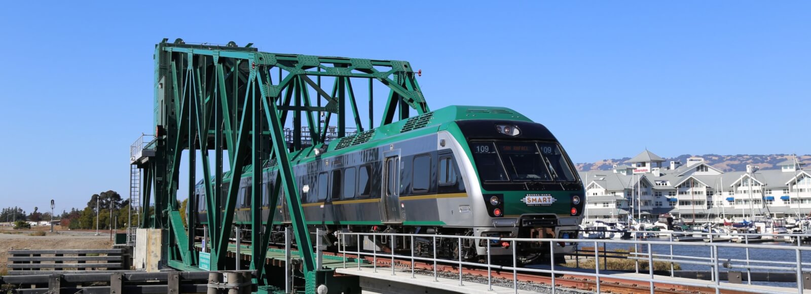 Plan your visit to petaluma 1 Smart train going over bridge with sheraton and marina across the river.