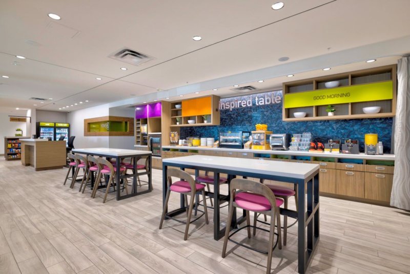 Common area, with light colored flooring and colorful furnishings.