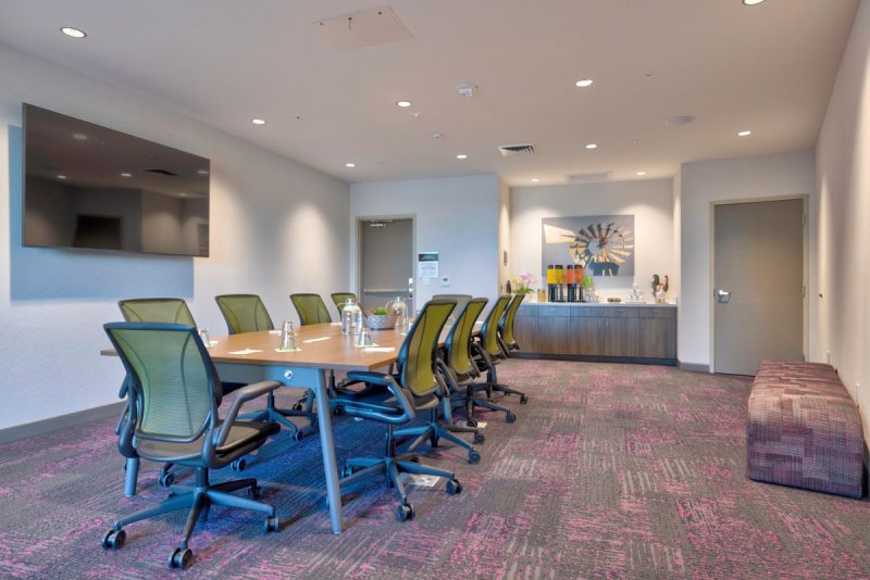 Business area, long table with chairs and outlets.