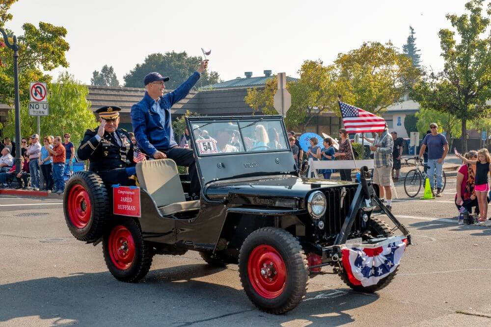 Petaluma veterans day parade & flyover 2 Congressman waving to crowd from jeep at veterans parade
