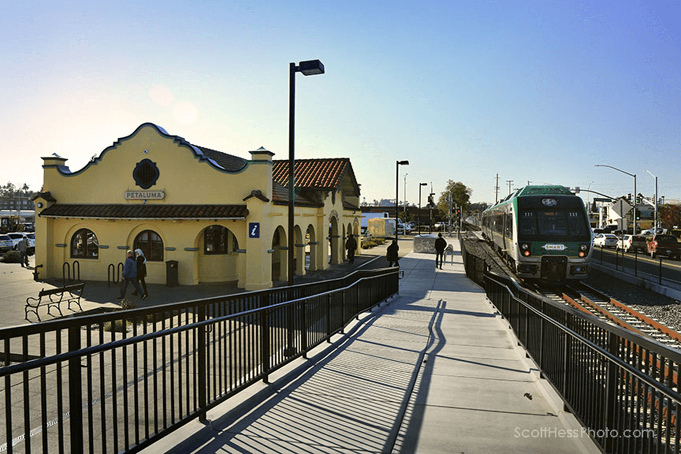 Travel smart to petaluma 1 Historic train station with adjacent modern platform and train.