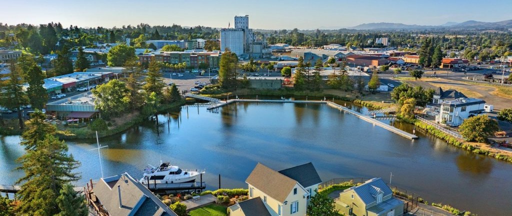 Petaluma, california 1 Aerial view of turning basin with grain mill in background and sailboat at dock.
