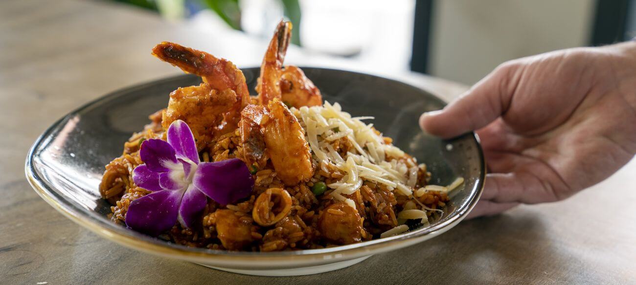 Shrimp dish with flower garnish.