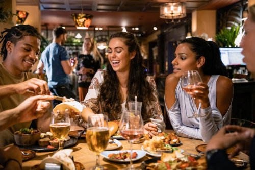 young people drinking and eating at a restaurant