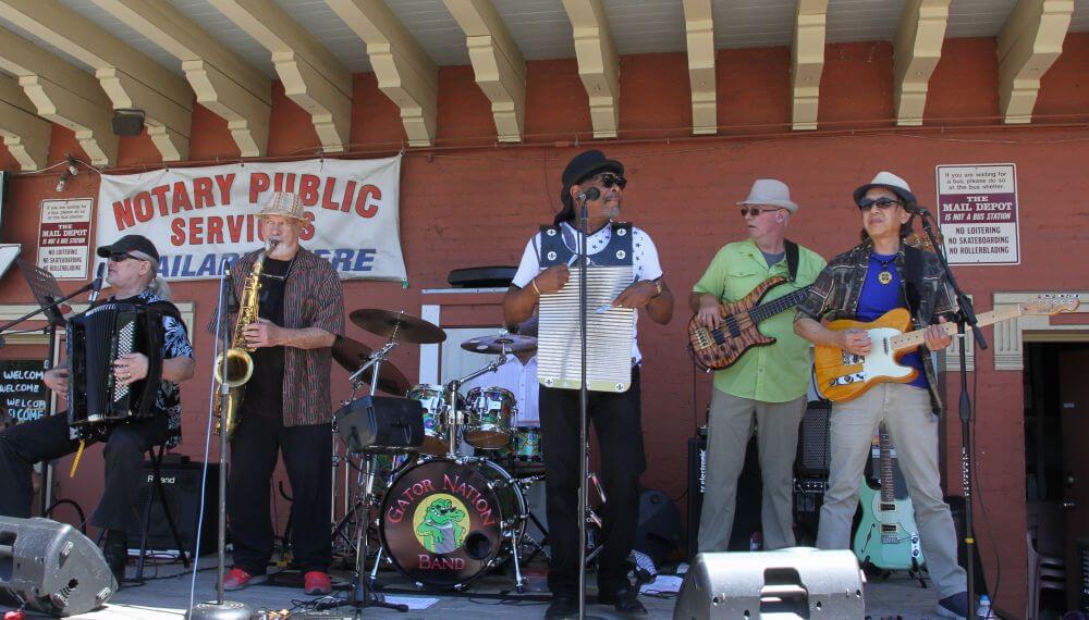 Band with sax and washboard on an outdoor stage