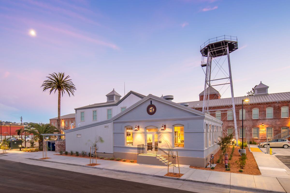 Historic building, palm tree, observation tower at dusk