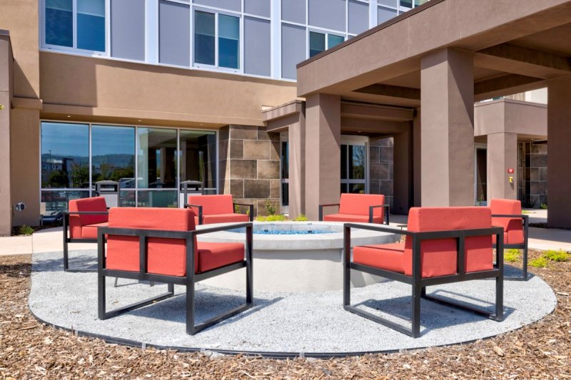 Red patio chairs near outdoor spa.