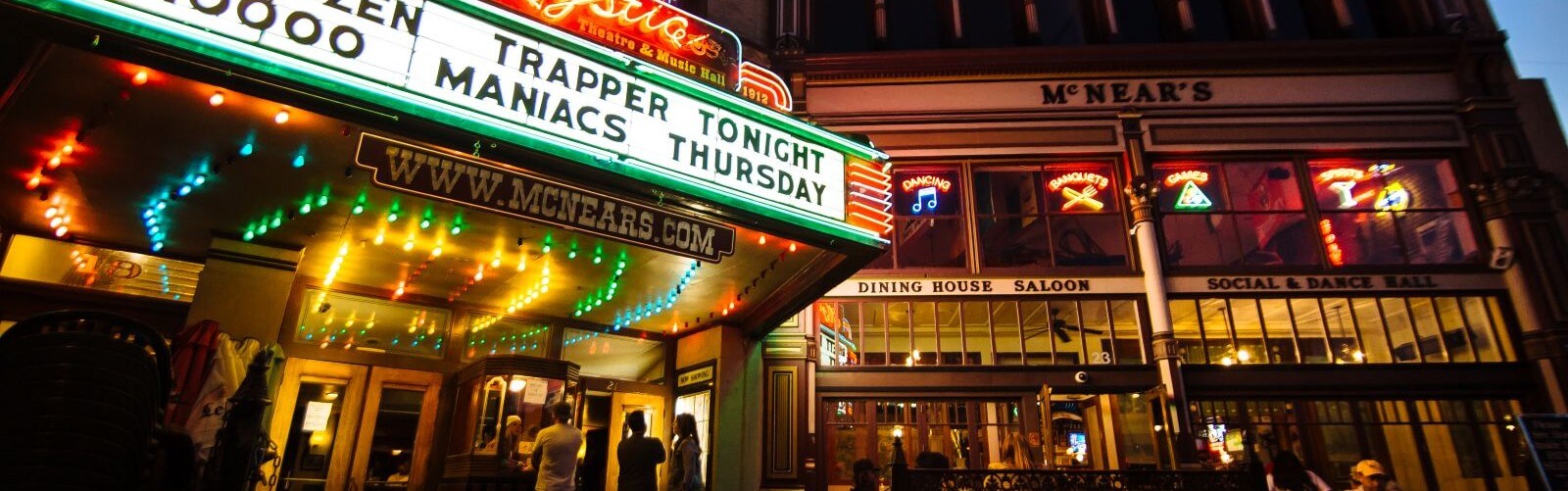 Mystic theatre marquis at night with historic building in background
