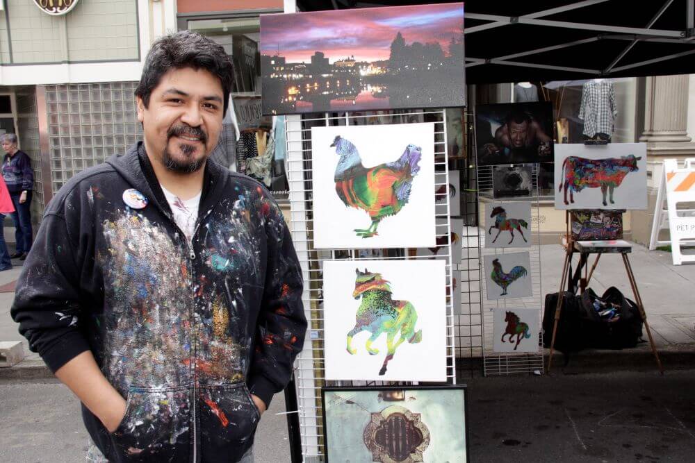 Painter with paintings of at street festival