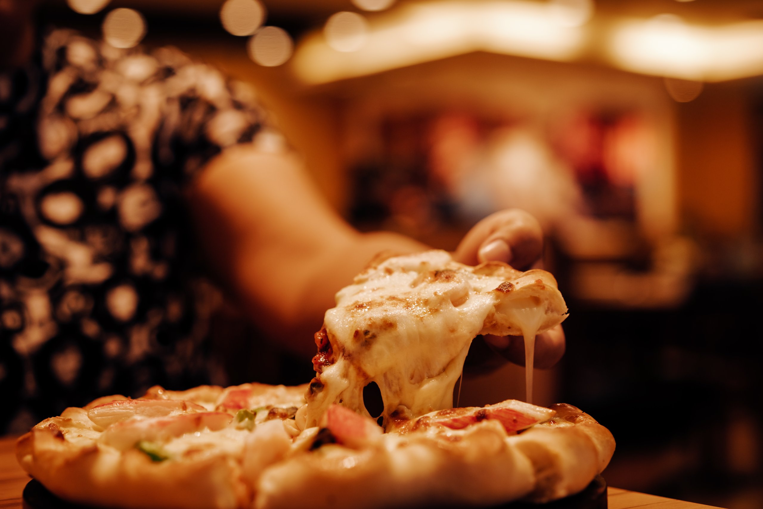 Best pizza parlors in petaluma 1 Person pulling cheesy slice from pizza