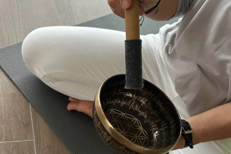 Person playing a singing bowl