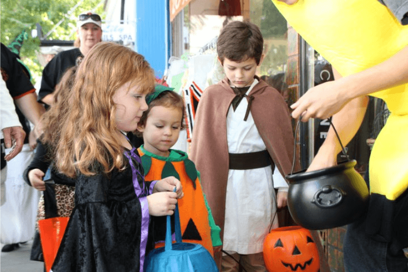 Children in costumes collecting candy