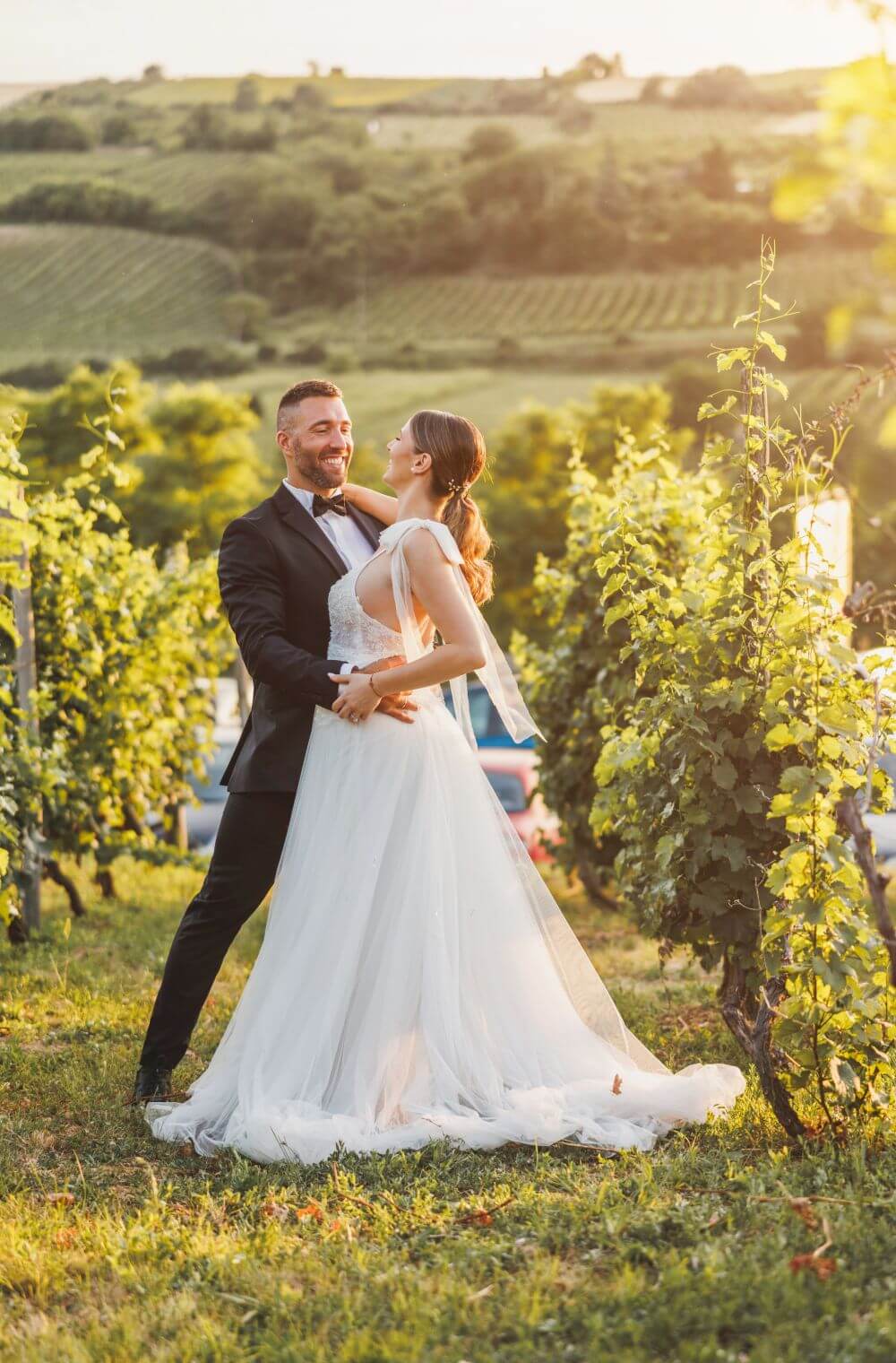 Plan your visit to petaluma 4 Wedding couple embracing in vineyard at sunset.